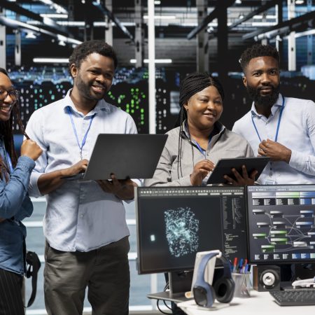 Cheerful data center experts working together, using deep learning algorithms and node trees to analyze datasets. Jolly server farm teamworking colleagues using AI to recognize facility data patterns