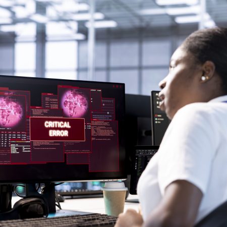 Engineer in server hub investigating breach alerts, working to protect equipment from hacker. Woman in data center employing various tools and technologies to identify and mitigate security risks