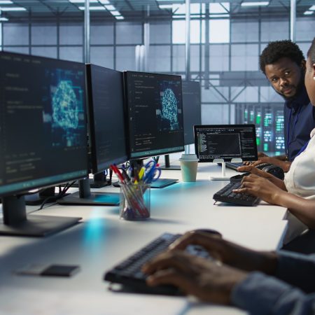 IT specialists in data center doing brainstorming, maintaining company network infrastructure. Team of server hub computer scientists chatting, ensuring optimal system performance, camera A